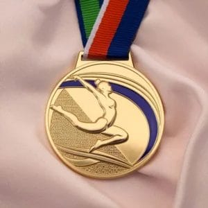 Gold medal featuring a female gymnast, symbolizing achievement in gymnastics competitions.