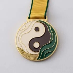 Custom fencing medal featuring a yin symbol with a vibrant green and gold design, showcasing elegance and achievement.
