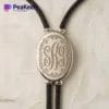 Silver monogrammed necklace with a leather cord, combining classic elegance with a contemporary bolo tie style.