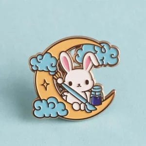 A cute enamel pin featuring a bunny sitting on a crescent moon against a starry background.