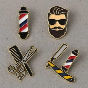 Set of colorful enamel pins featuring barber tools and symbols, perfect for barbershop enthusiasts and collectors.